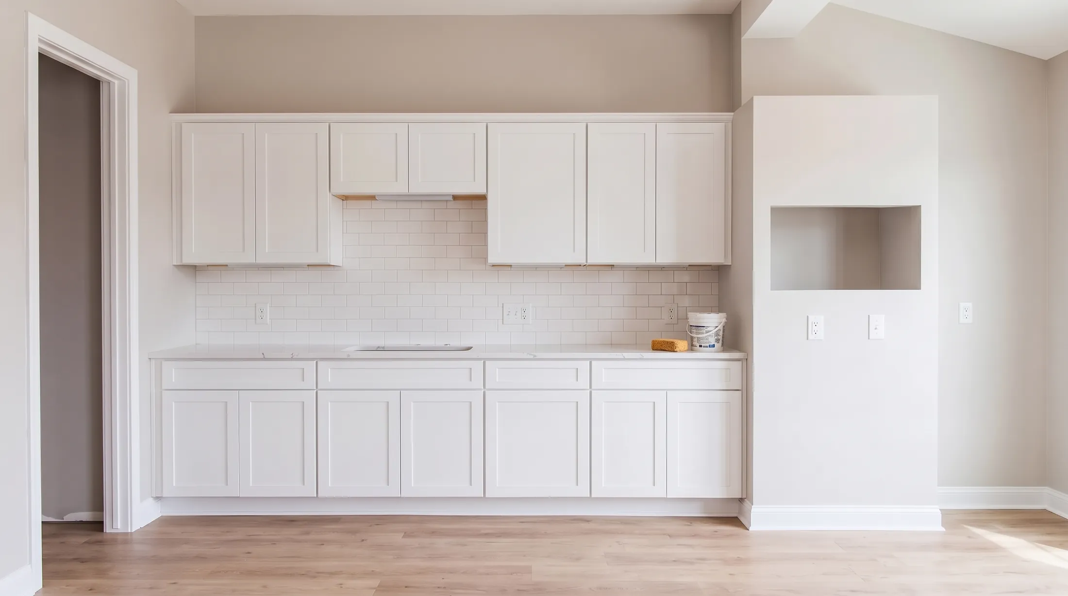 The same room with the white subway tile backsplash up