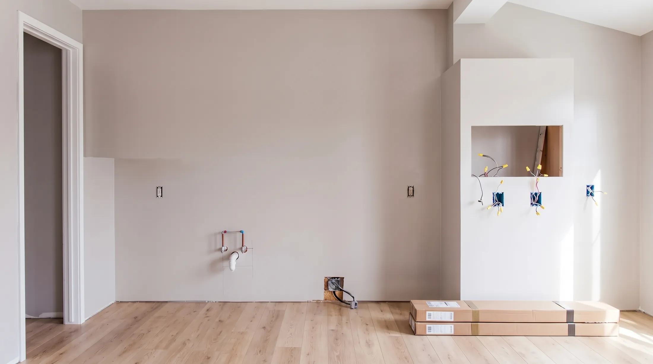 The same room with the new light oak floor laid and the cabinet boxes waiting
