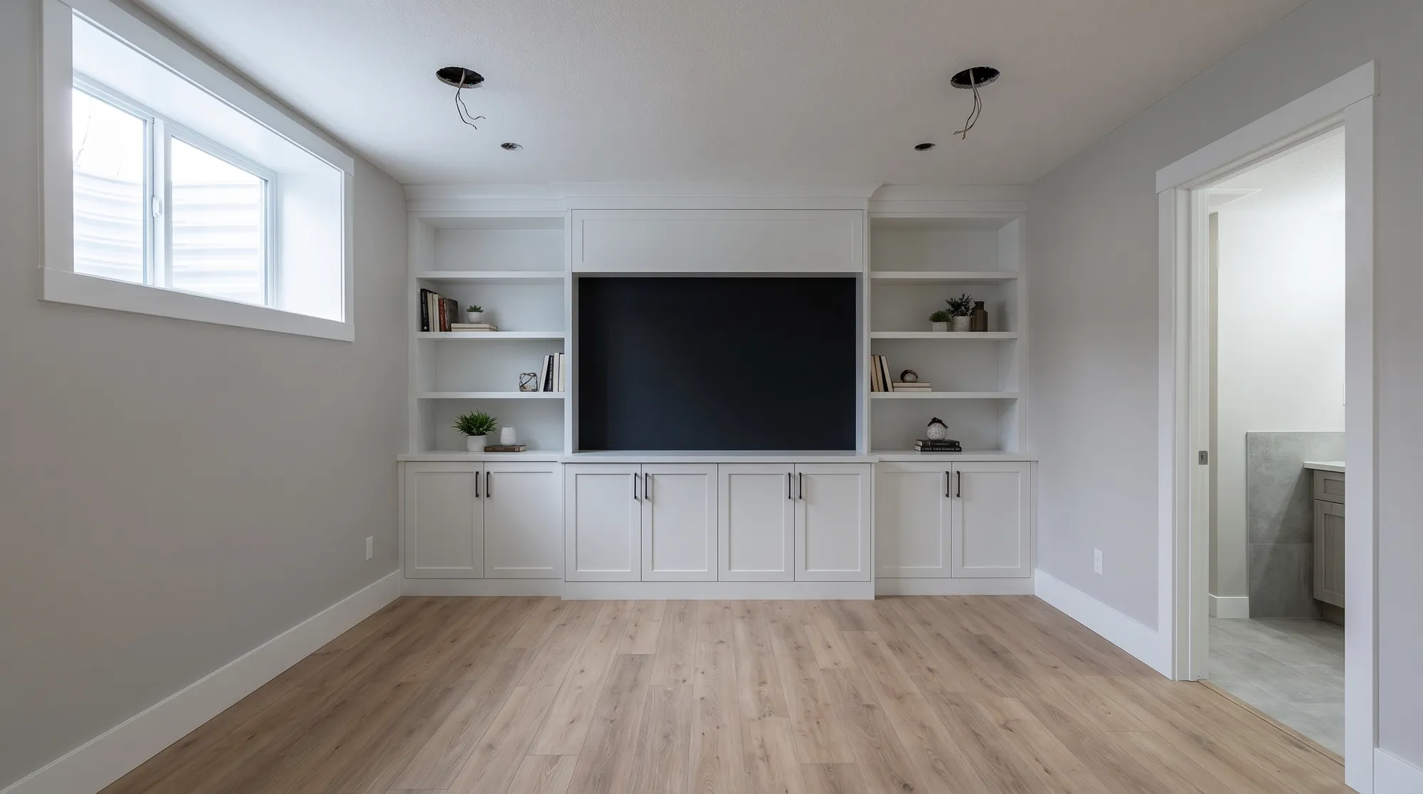 The same basement with the built-in media wall and trim in