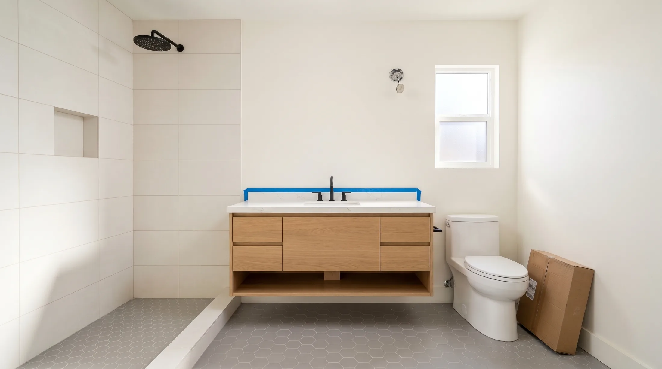 The same bathroom with the oak floating vanity, quartz top and the toilet in, the glass still to come